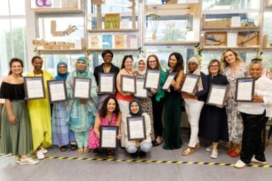 Image of 15 participants in the Agents of Change Women's Community Leadership Programme celebrating their graduation at the Invention Rooms in White City on Thursday 22 June.