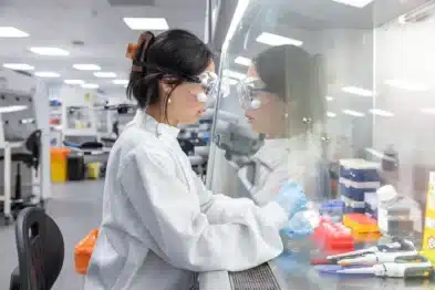 A scientist in a white lab coat pictured working in the Bezos Centre for Sustainable Protein